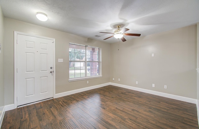 foyer featuring a textured ceiling, dark hardwood / wood-style flooring, and ceiling fan