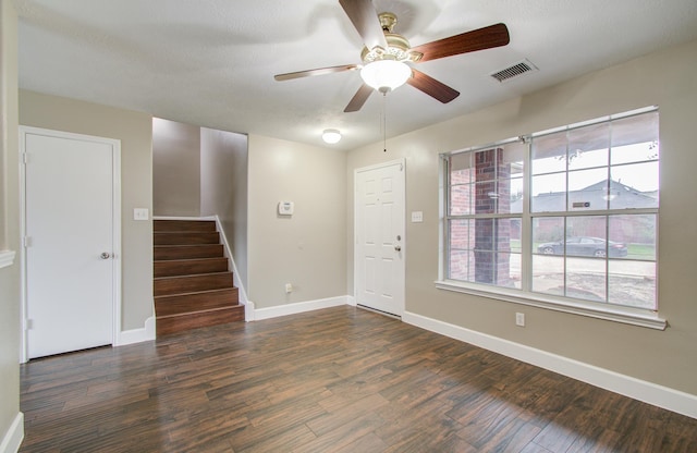 foyer entrance featuring plenty of natural light, dark hardwood / wood-style floors, and ceiling fan