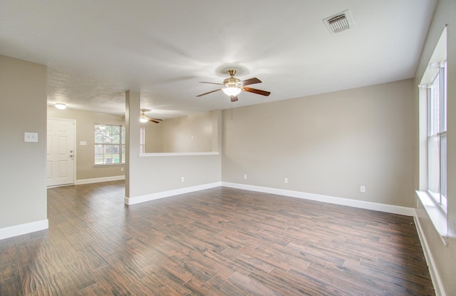 unfurnished room featuring dark hardwood / wood-style floors and ceiling fan