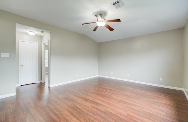 empty room featuring ceiling fan, dark wood-type flooring, and lofted ceiling