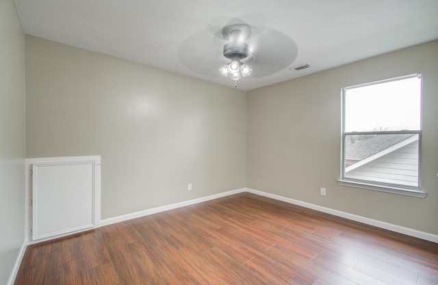 unfurnished room with dark hardwood / wood-style flooring and ceiling fan