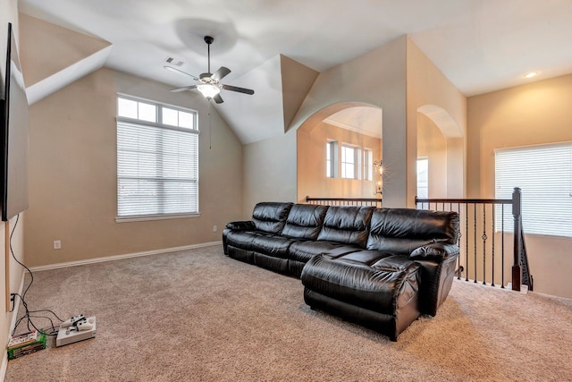 carpeted living room with ceiling fan and lofted ceiling