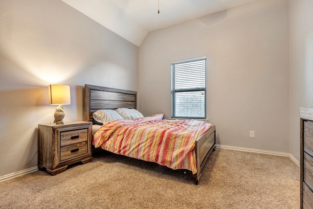 bedroom featuring lofted ceiling, baseboards, and light colored carpet