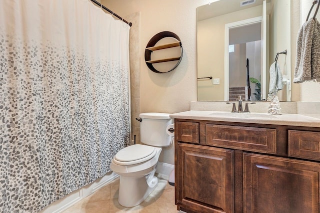 bathroom with vanity, curtained shower, tile patterned floors, and toilet