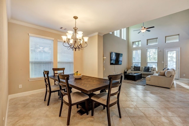 tiled dining room with crown molding, a towering ceiling, and plenty of natural light