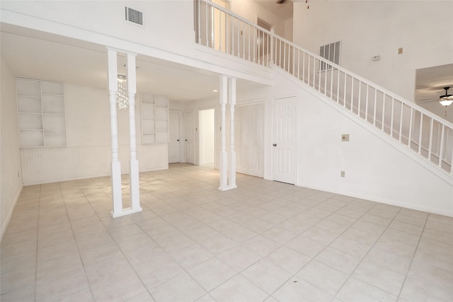 interior space with ceiling fan and light tile patterned flooring