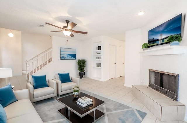 living room featuring tile patterned floors, built in features, and ceiling fan