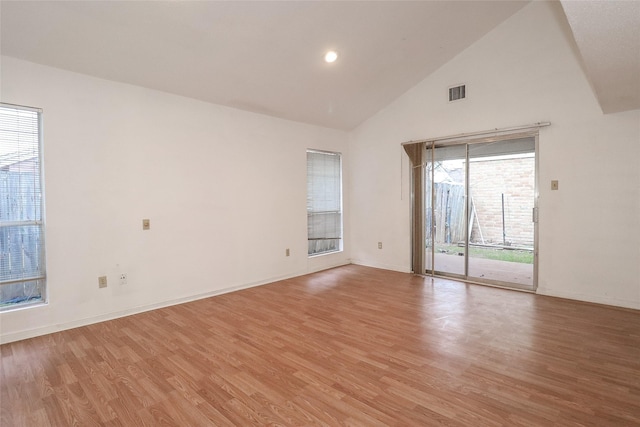 unfurnished room with high vaulted ceiling and light hardwood / wood-style floors