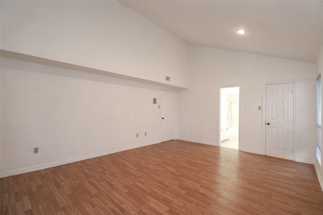 unfurnished room featuring hardwood / wood-style floors and high vaulted ceiling