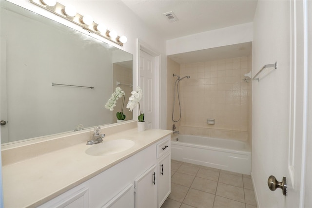 bathroom featuring tile patterned floors, tiled shower / bath combo, and vanity