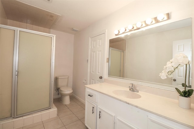 bathroom with tile patterned flooring, vanity, toilet, and an enclosed shower