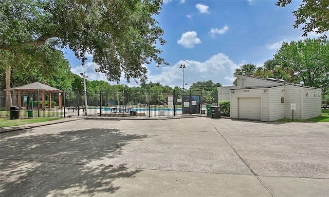 exterior space with a gazebo and a community pool