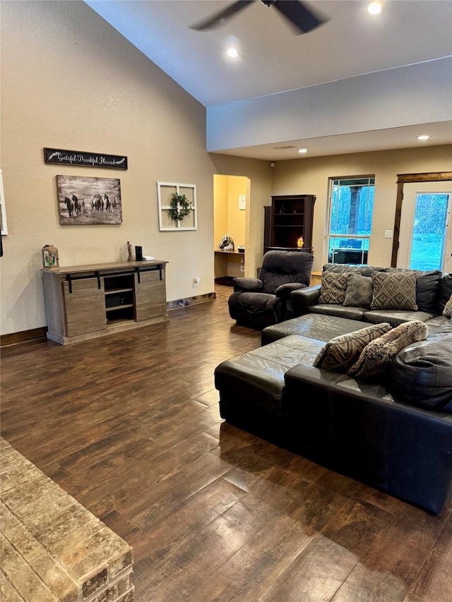 living room with ceiling fan and dark hardwood / wood-style flooring