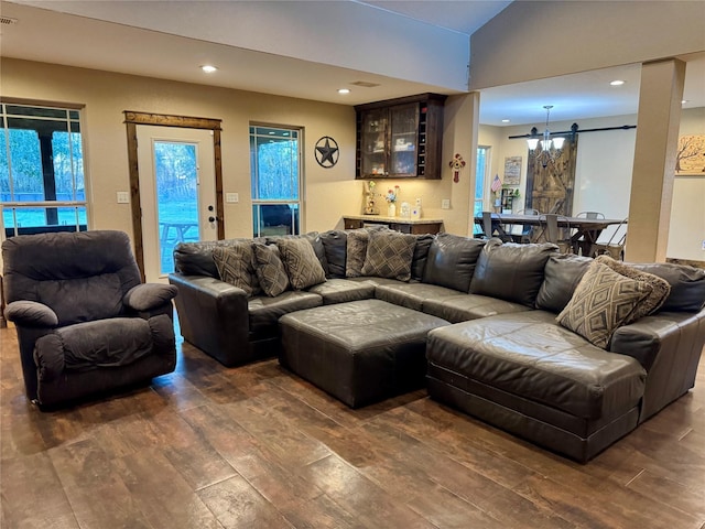 living room featuring dark hardwood / wood-style flooring, vaulted ceiling, and bar