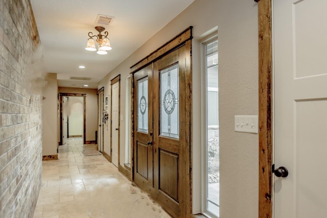 foyer entrance with a chandelier