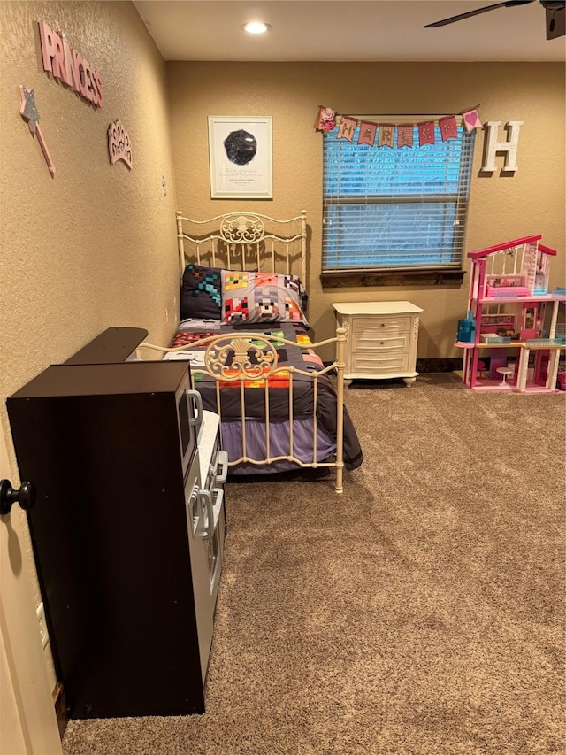 carpeted bedroom with ceiling fan