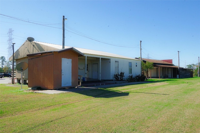 back of property featuring a yard