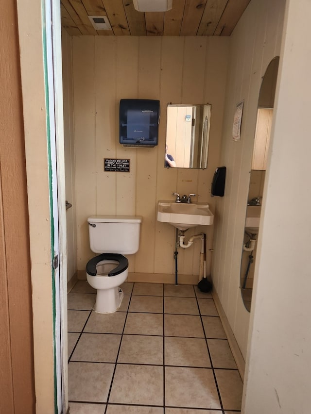 bathroom with sink, toilet, tile patterned floors, and wooden ceiling