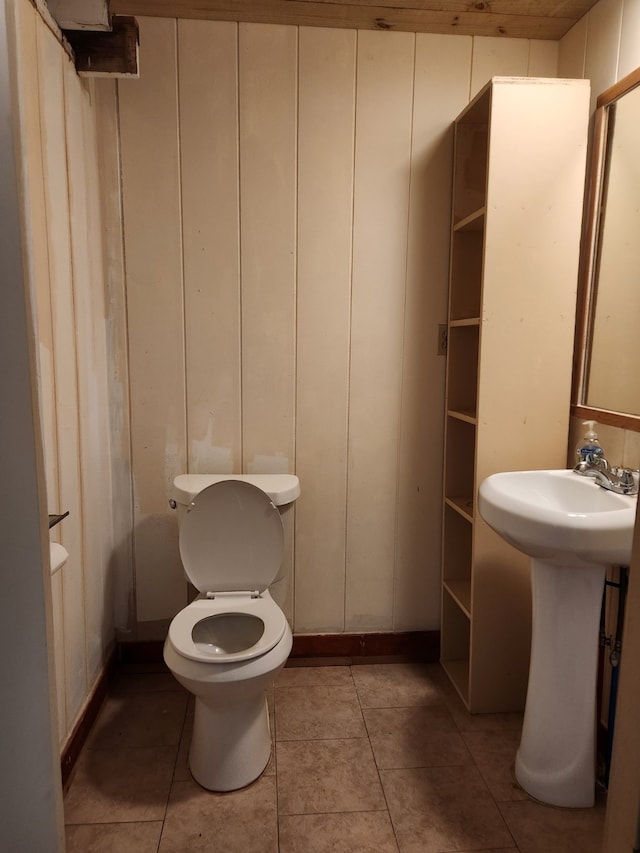 bathroom with sink, toilet, and tile patterned flooring