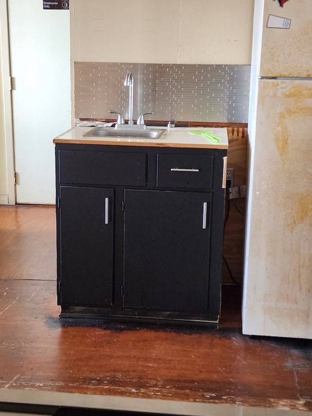 kitchen featuring dark hardwood / wood-style flooring, sink, and white refrigerator