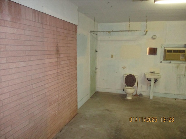 garage featuring a wall mounted air conditioner and sink