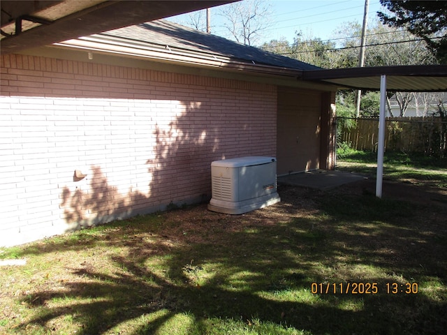 view of side of home with a lawn