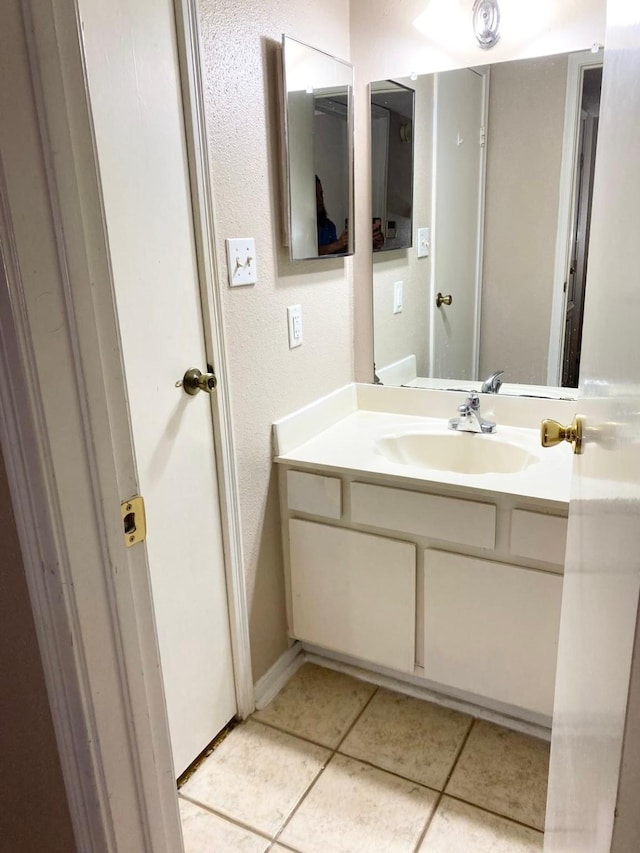 bathroom with tile patterned floors and vanity