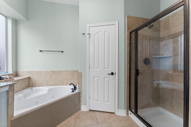 bathroom featuring shower with separate bathtub and tile patterned flooring