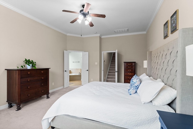 bedroom featuring light carpet, ornamental molding, ceiling fan, and ensuite bathroom