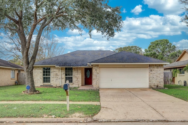 single story home with a front yard and a garage