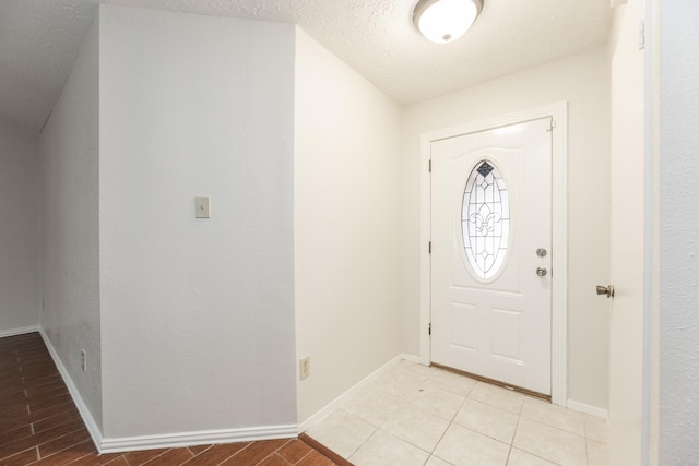 foyer entrance with a textured ceiling