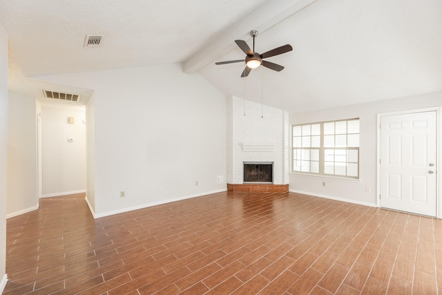 unfurnished living room with vaulted ceiling with beams, ceiling fan, and a fireplace