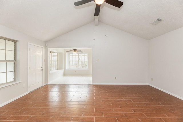 spare room featuring vaulted ceiling with beams and ceiling fan