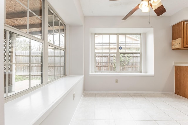 unfurnished dining area featuring ceiling fan