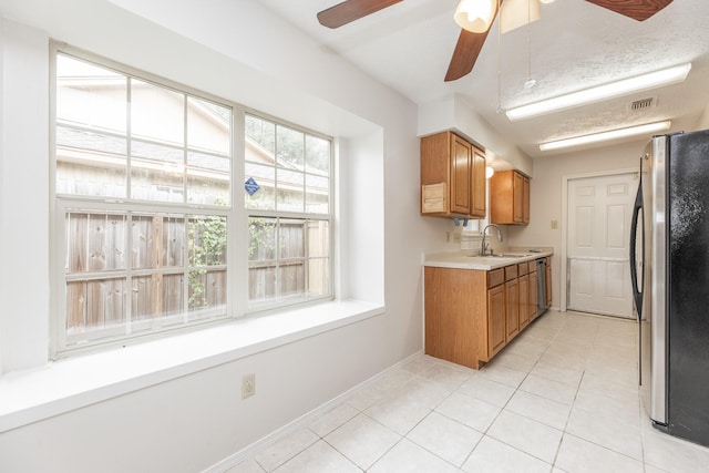 kitchen with ceiling fan, light tile patterned floors, sink, and appliances with stainless steel finishes