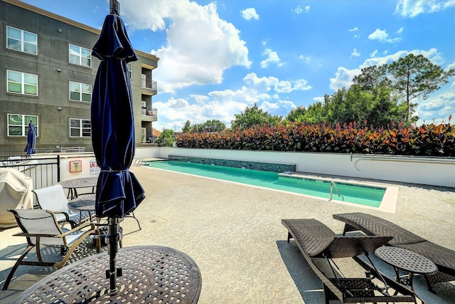 view of pool featuring a patio