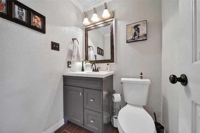 bathroom with crown molding, vanity, wood finished floors, and a textured wall