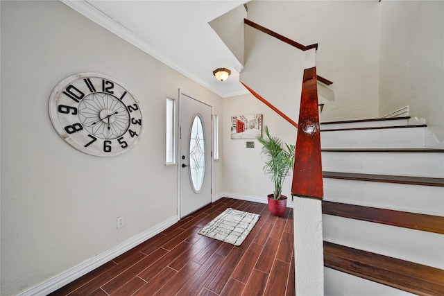 foyer with wood tiled floor, ornamental molding, and baseboards