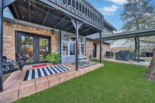 exterior space with central AC, french doors, and a grill