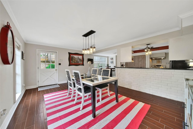 dining room with a ceiling fan, baseboards, crown molding, and wood finish floors