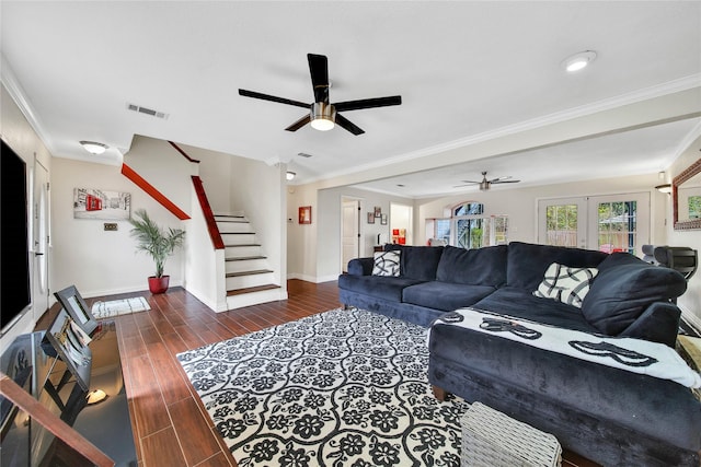 living room with dark wood-style flooring, crown molding, stairway, and baseboards