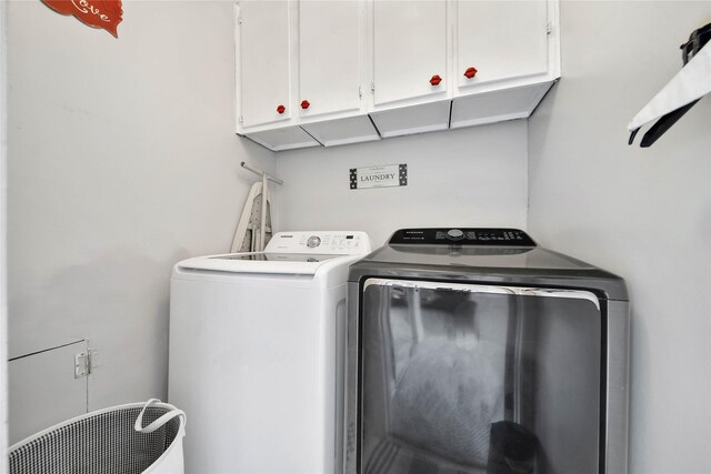 laundry area with cabinet space and independent washer and dryer