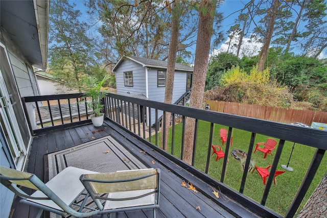 wooden deck with fence and a lawn