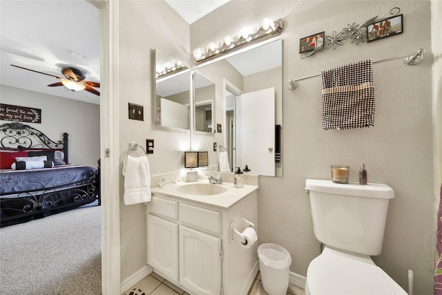 bathroom with baseboards, toilet, ceiling fan, ensuite bathroom, and vanity