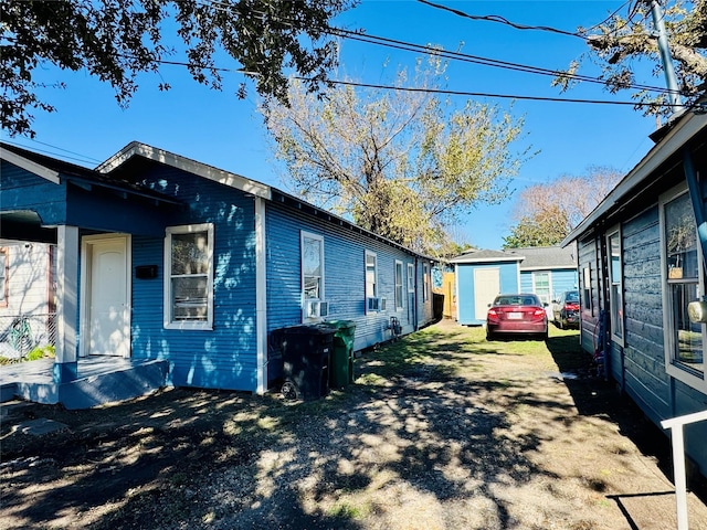 view of side of property featuring a storage unit