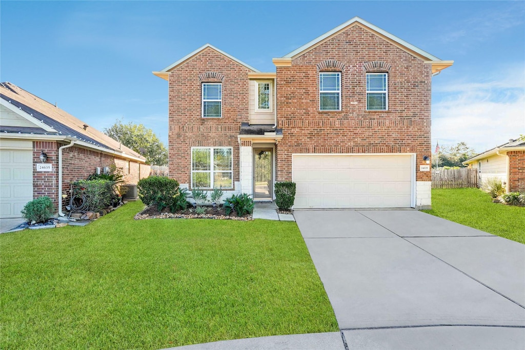 view of property featuring central AC, a garage, and a front lawn