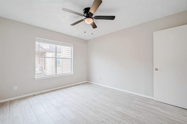 spare room featuring ceiling fan, a textured ceiling, and light hardwood / wood-style flooring