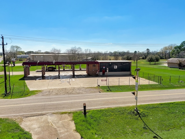 view of property's community with a lawn and a carport