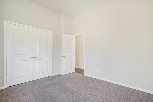 unfurnished bedroom featuring carpet and a closet