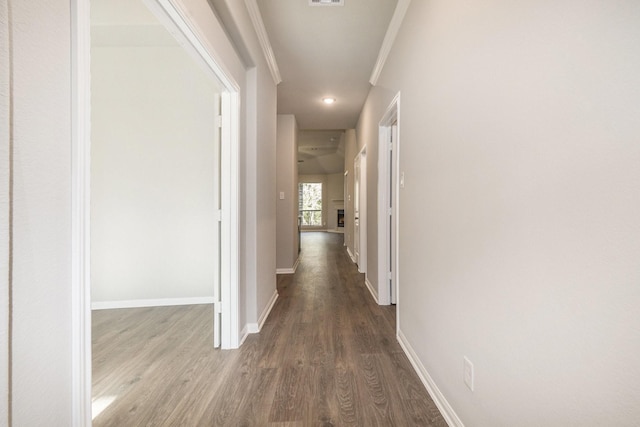 hallway with hardwood / wood-style flooring and crown molding